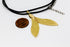 products/SA0213100150101-Necklaces-MermaidTailShaped-SGold-XS-KingKongLeaf-BlackLeatherCordS-01.jpg